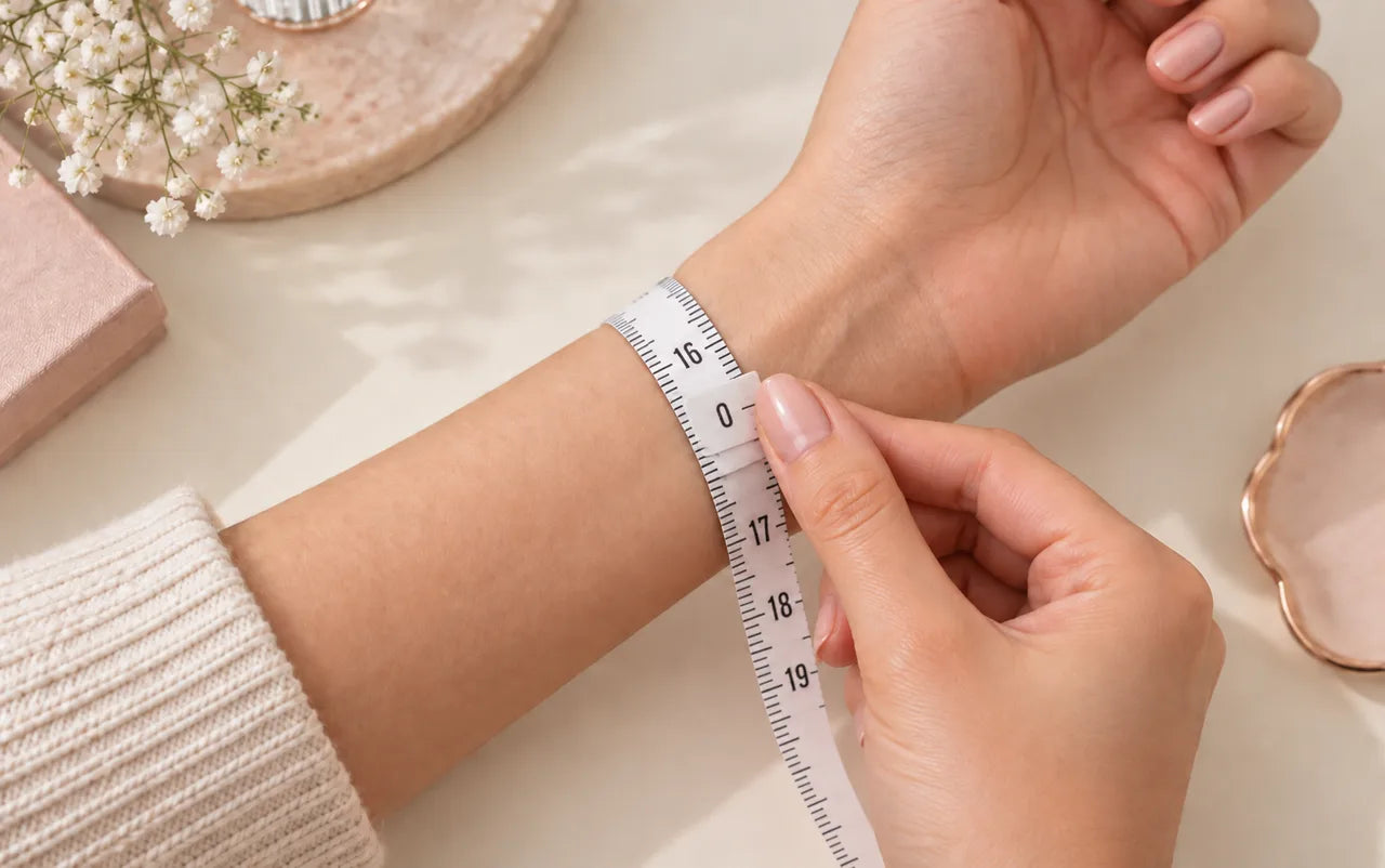 A soft measuring tape wrapped naturally around the wrist with the zero end meeting the measurement